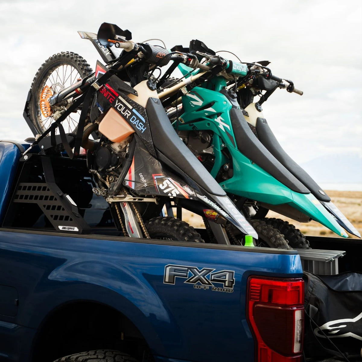 Pickup truck Chase Rack System transporting three off-road motorcycles with secure tie-down mounts