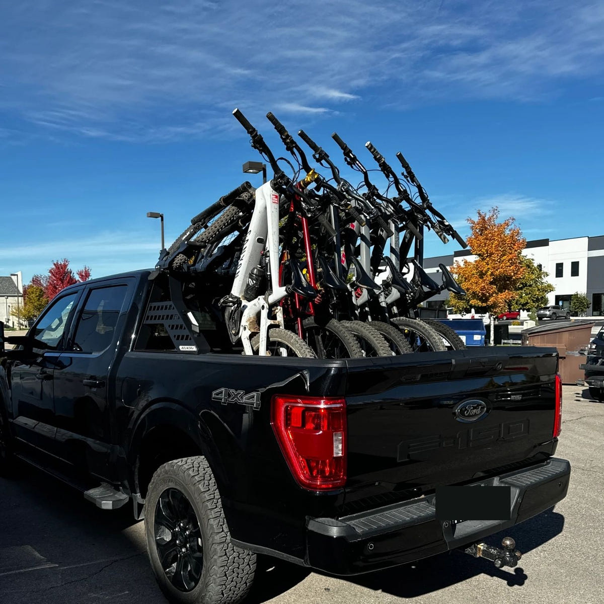 Truck bed bike rack with Heretic LED light bar for shuttle and trail riding