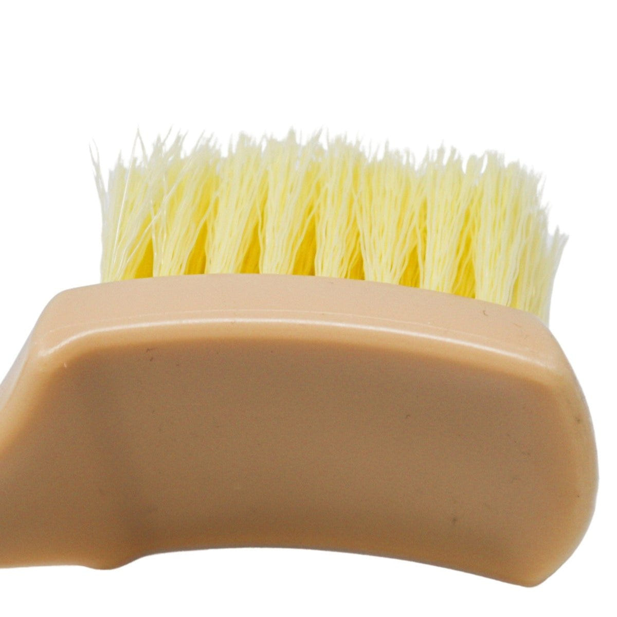Beige brush with yellow bristles on a white background
