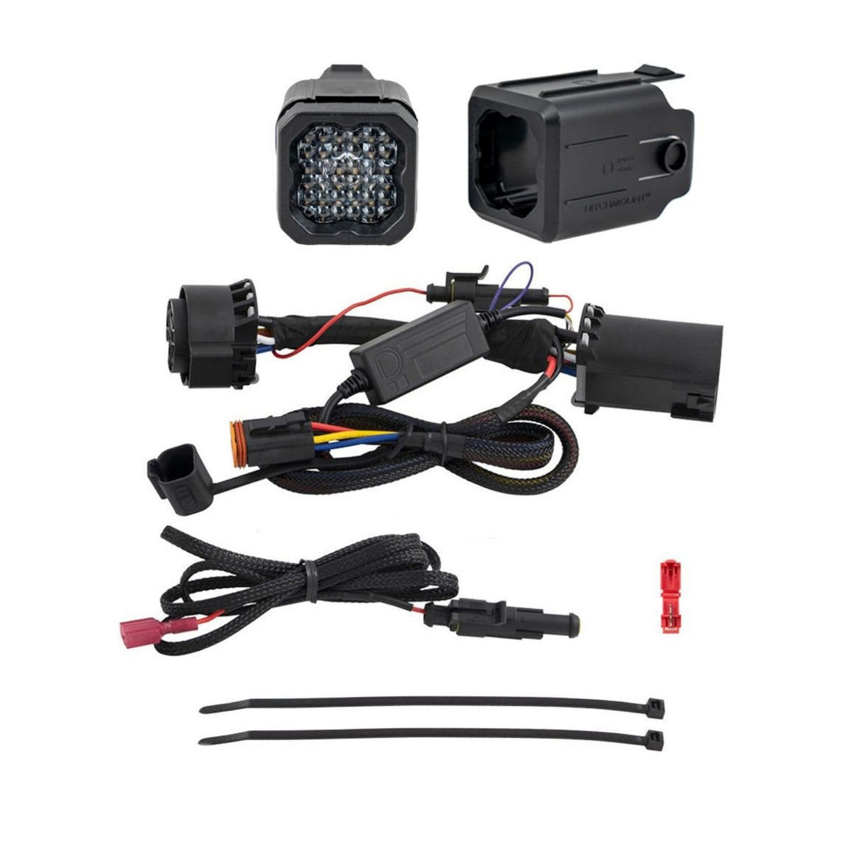 Hitch-mounted auxiliary reverse light for trucks with a factory 7-pin trailer connector