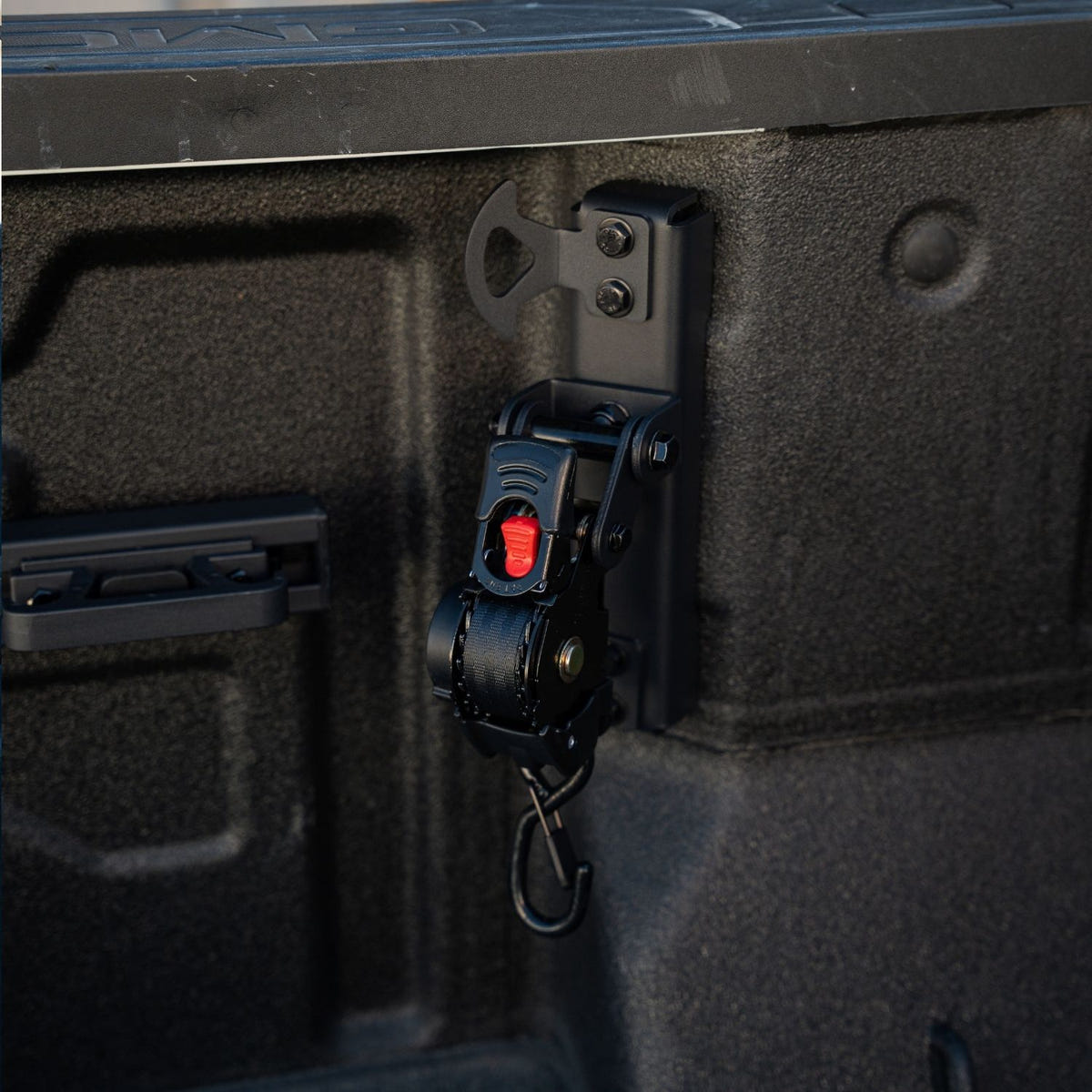 Integral truck bed swivel strap featuring a 1-inch by 10-foot retractable tie-down strap