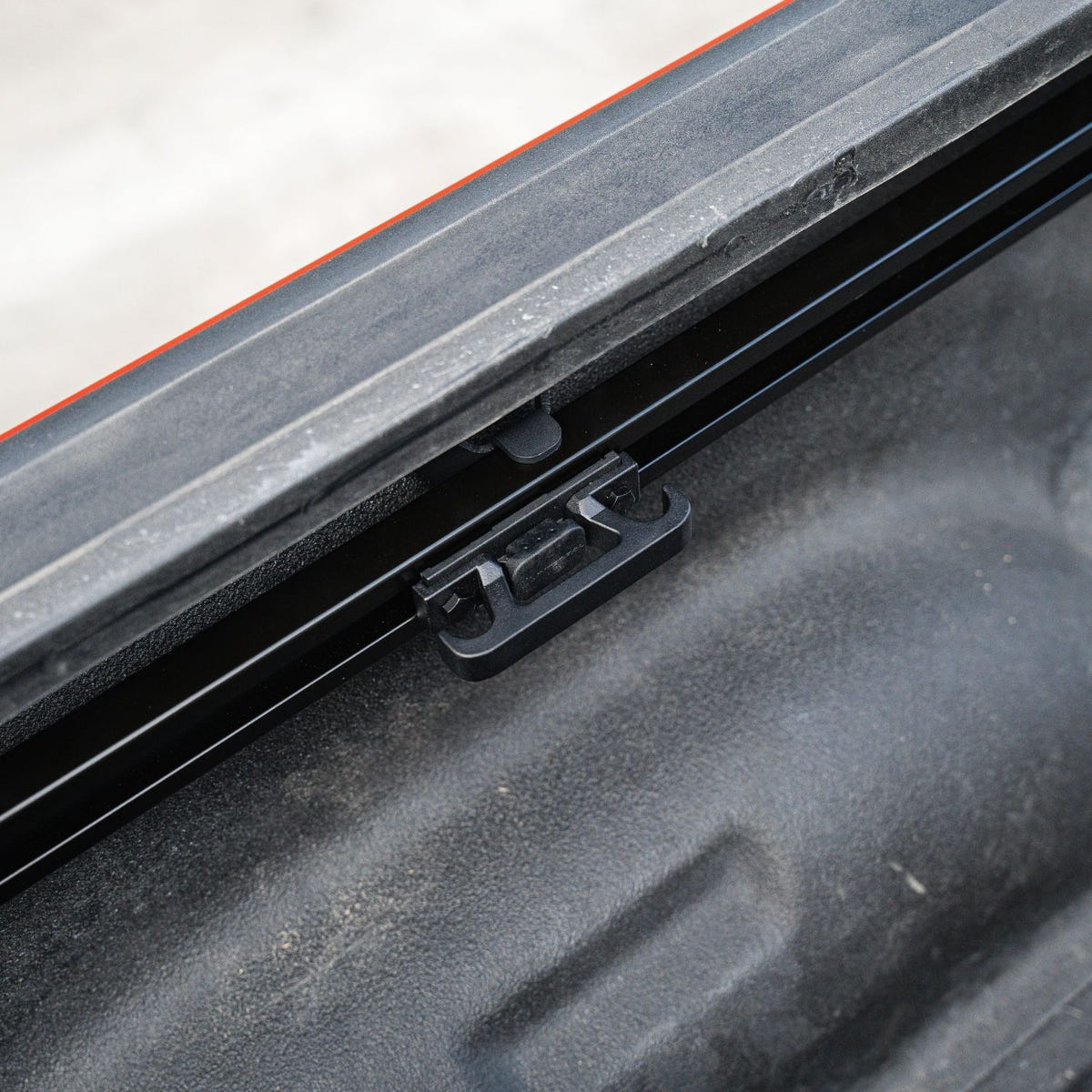 Integral Truck rail-mounted tie-down cleat for securing cargo