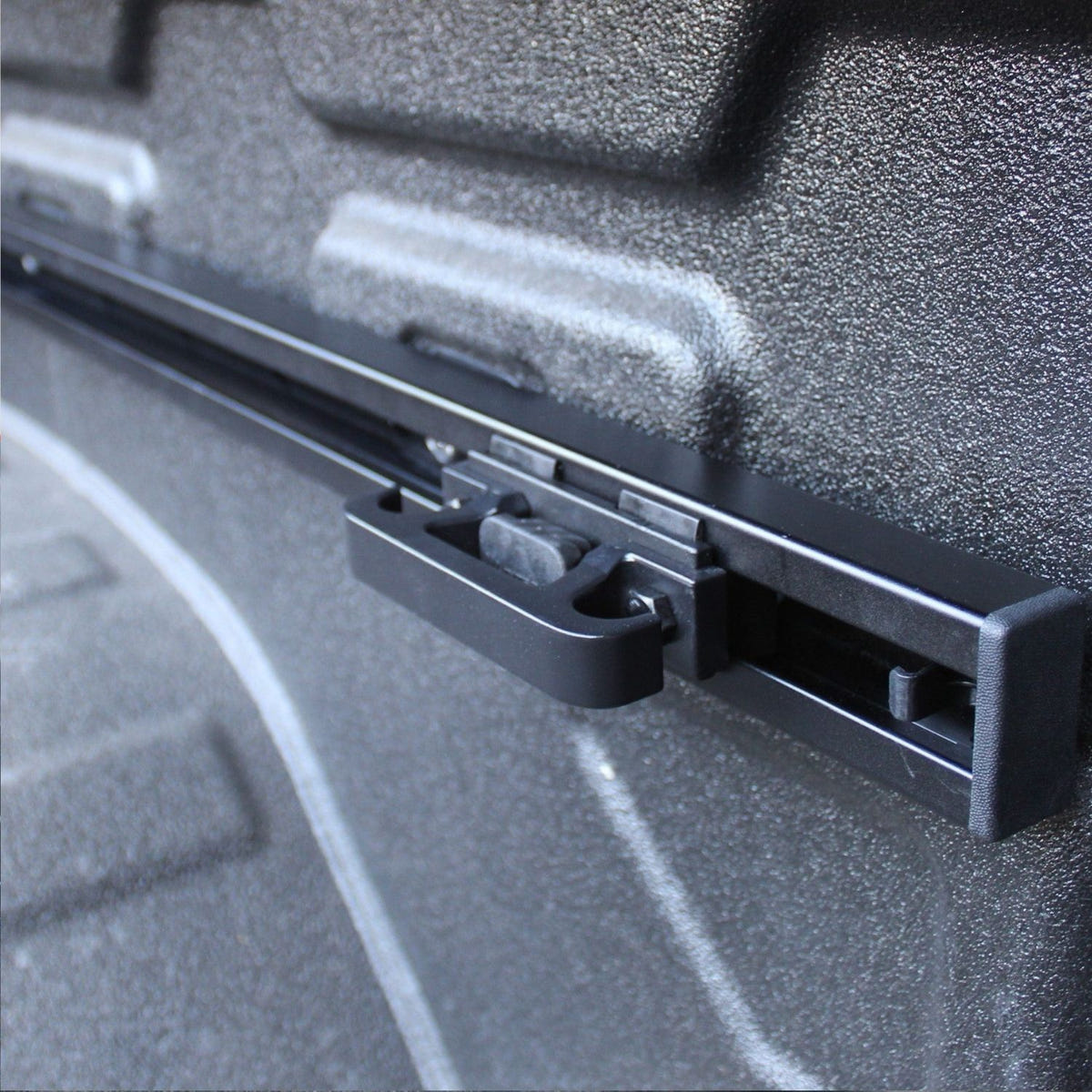Adjustable cargo tie-down cleat for Integral bed rail systems