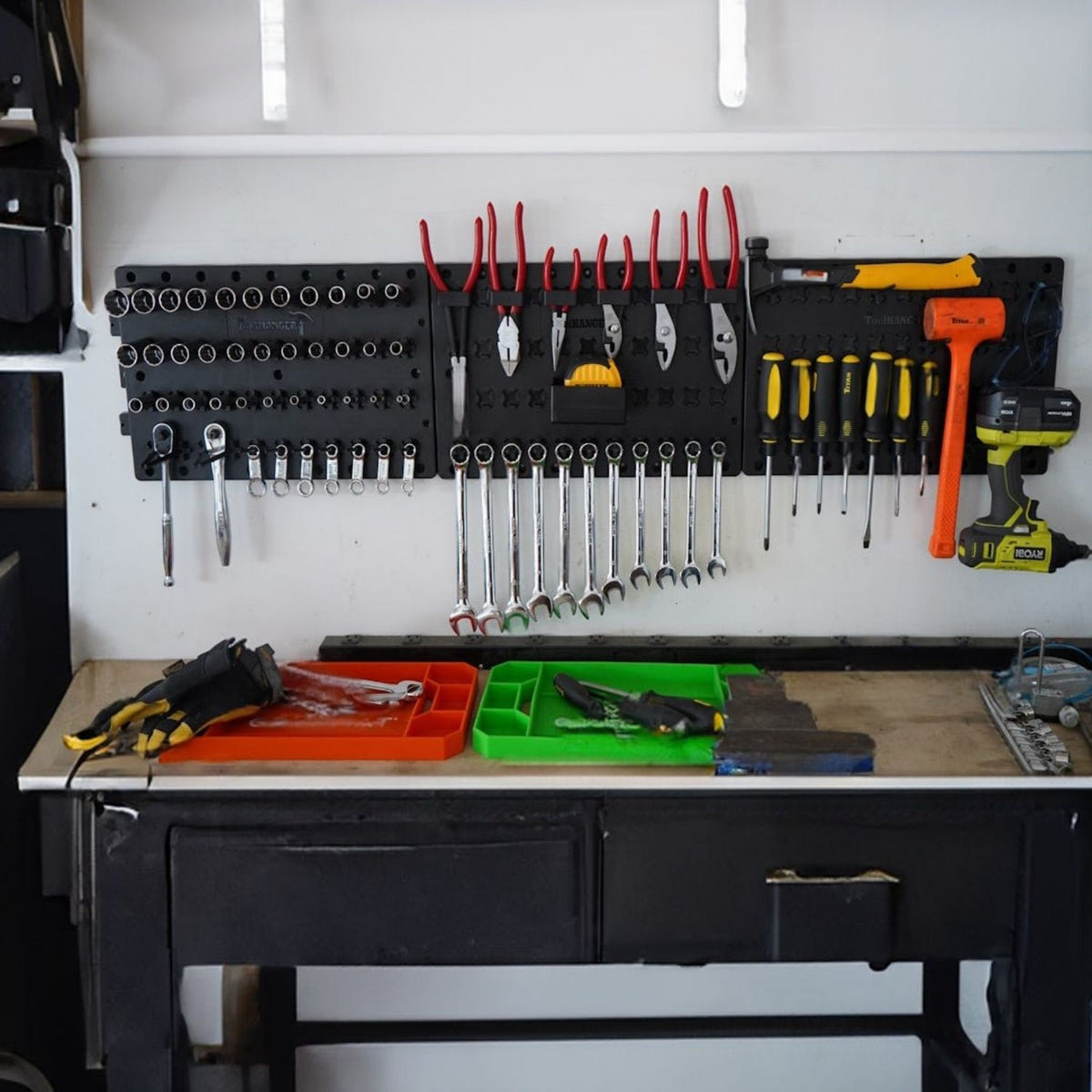 Wall-mounted ToolHanger organizer holding screwdrivers, pliers, sockets, and hand tools