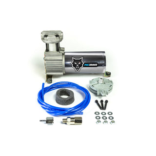 An air brake booster kit including a silver metallic pump cylinder with a black and blue PAC BRAKE logo, a coiled blue hose, a gray foam plug, mounting hardware, and washers, arranged on a white background.