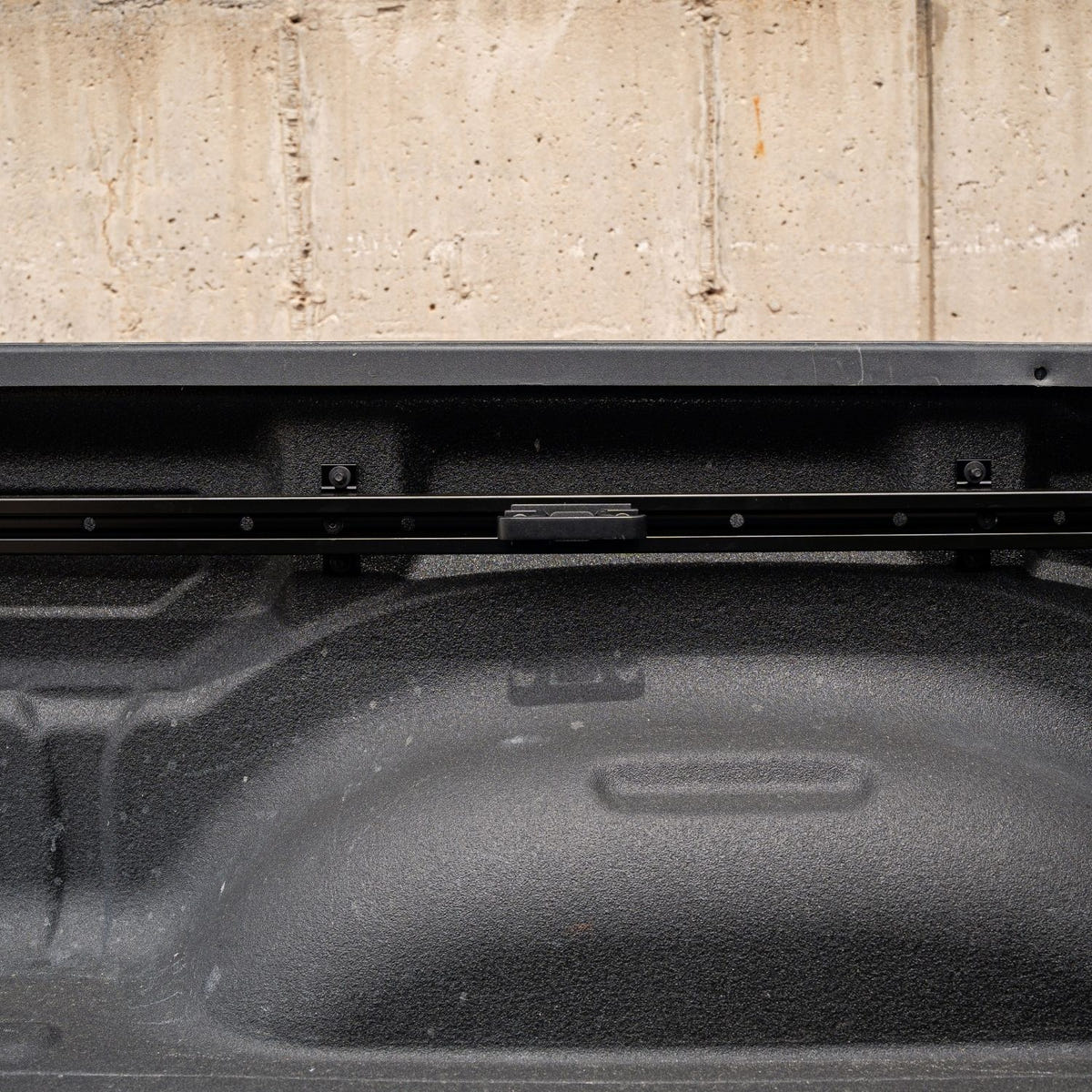 Close-up of the Integral Slide-N-Lock cleat mounted to an aluminum bed rail on a Ram 1500