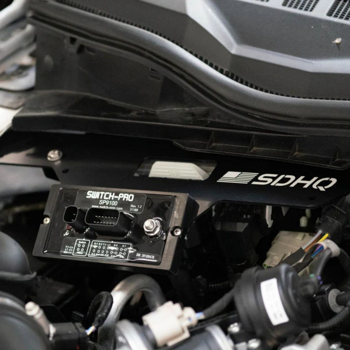 SDHQ Built aluminum Switch-Pros control module mount for Ford Super Duty engine bay