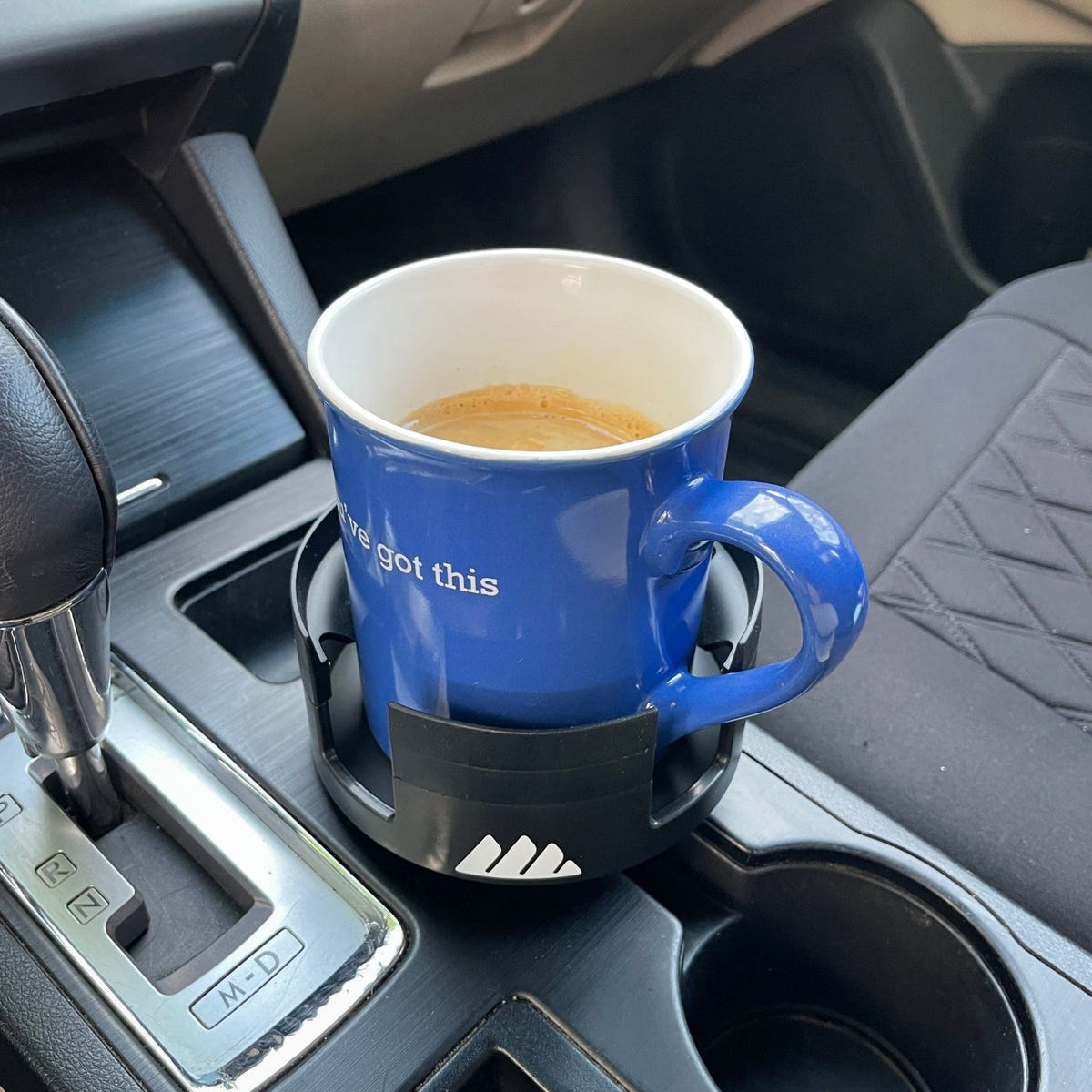 Integral Mug Integrator holding a YETI-style travel mug in a vehicle
