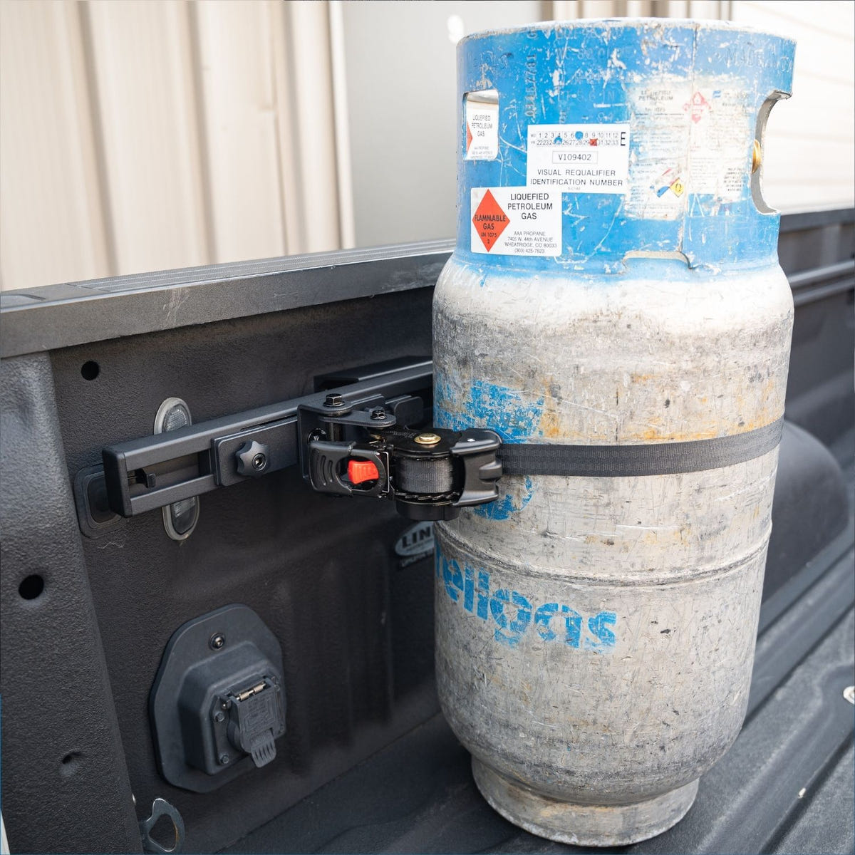 Integral Rail compatible retractable cargo strap with patented triple-pivot storage joint