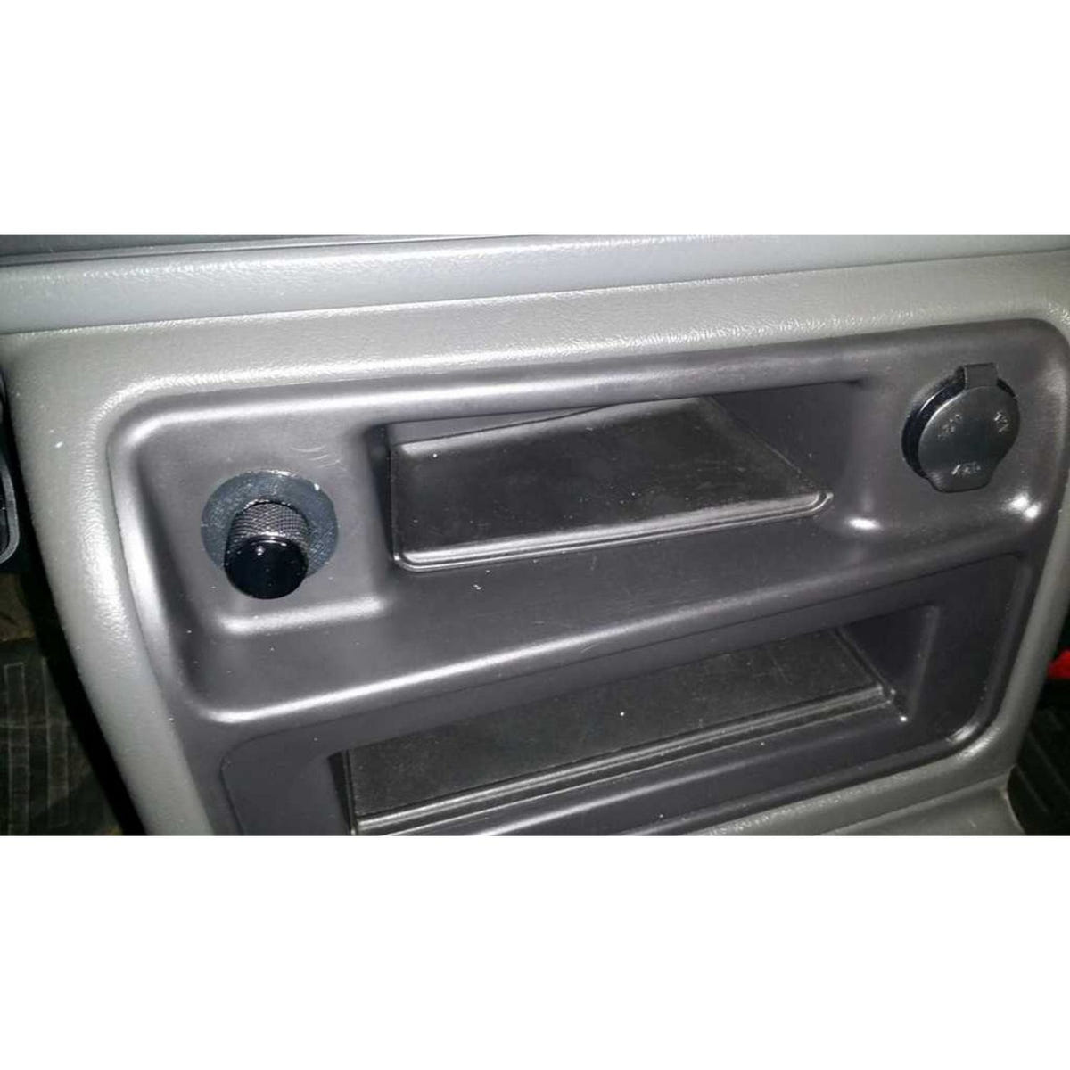 OEM-style DSP5 switch mount replacing the factory cigarette lighter on a 2001-2007 Duramax or 2007.5-2009 Cummins truck